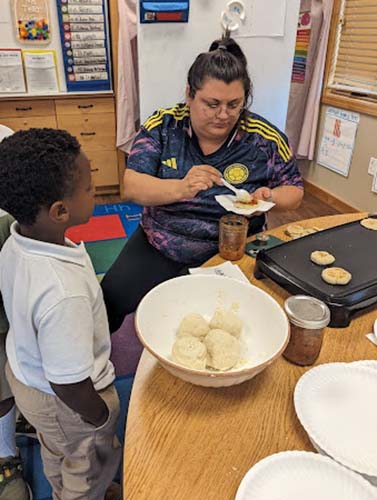Hispanic Heritage Month - students watching how Columbian arepas are made