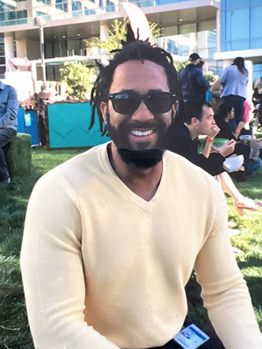 Smiling man in yellow sweater