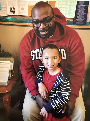 Man in red sweatshirt with his little daughter