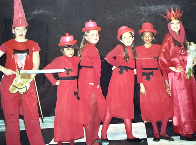 Girls in red costumes putting on a show