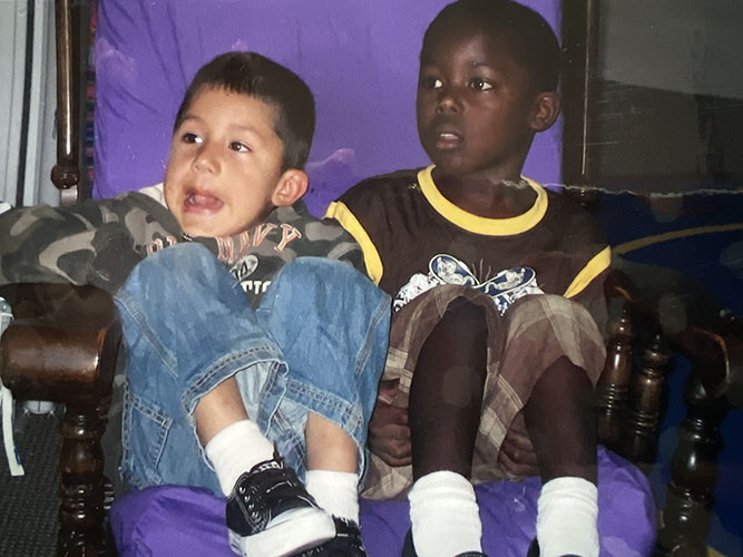 Two boys sitting in a rocking chair